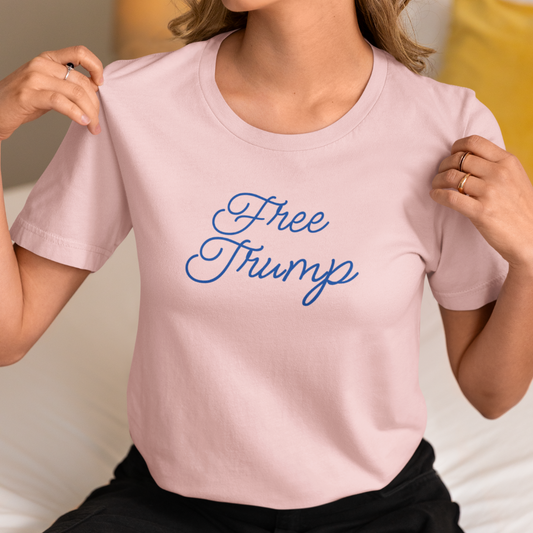 Get trendy with "Free Trump"  Unisex Jersey Short Sleeve Tee (Blue cursive text) - T-Shirt available at Good Gift Company. Grab yours for $16 today!