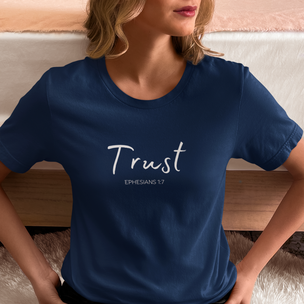 Get trendy with Trust (Ephesians 1:7)T-Shirt: Words of Faith Series (white text) - T-Shirts available at Good Gift Company. Grab yours for $21.95 today!